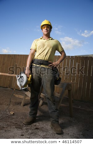 Man Confidently Holding Circular Saw Imagine de stoc © iofoto