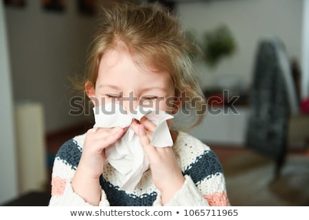 Stock photo: Young Girl Blowing Her Nose
