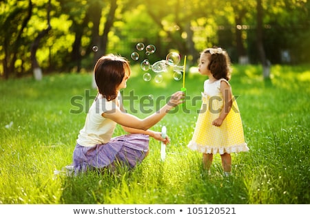Сток-фото: Family Playing With Bubbles In Garden
