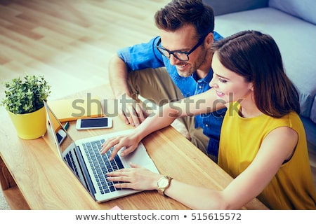 Foto stock: Two Women Using Laptop And Phone On Sofa
