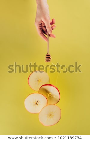 Stock photo: Partial View Of Female Hand And Levitating Pieces Of Apple