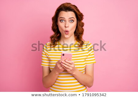 Stock photo: Girl With Red Hair On A Yellow Background A Charming Girl With Transparent Glasses Folded Her Arms