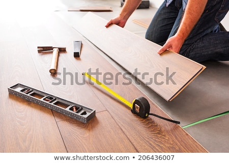 [[stock_photo]]: Man Installing New Laminate Wood Flooring