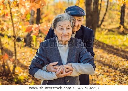 Stock fotó: Happy Senior Citizens In The Autumn Forest Family Age Season And People Concept - Happy Senior Co