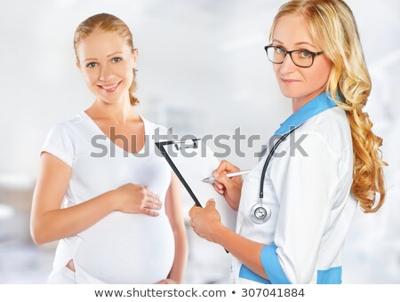 Foto stock: Doctor Feeling A Womans Pregnant Stomach