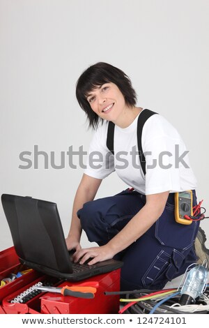 Сток-фото: Female Electrician Surrounded By Equipment