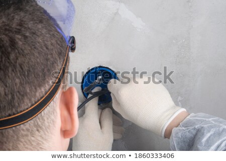 Stok fotoğraf: Close Up Of Male In Gloves Installing New Socket