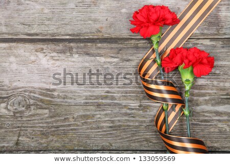 Stok fotoğraf: St George Ribbon And Carnations On Wooden Background