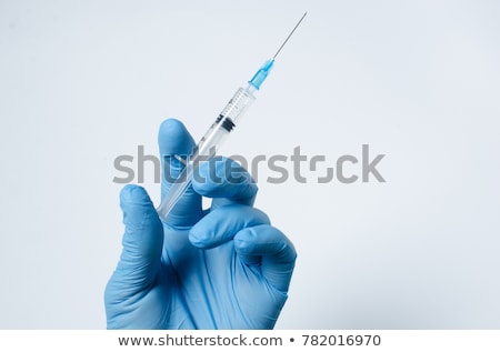 Foto stock: Nurse Holding Syringe In Hand Isolated