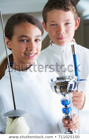 ストックフォト: Smiling Girl Holding Fencing Trophy