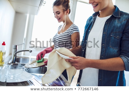 Foto stock: Young Happy Couple Washing Dishes