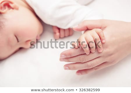 Stock photo: Close Up Of Mother Holding Sleeping Asian Baby Boy