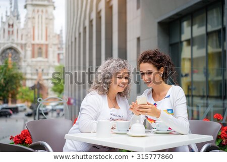Stock photo: Daughter And Senior Mother With Smartphone At Cafe