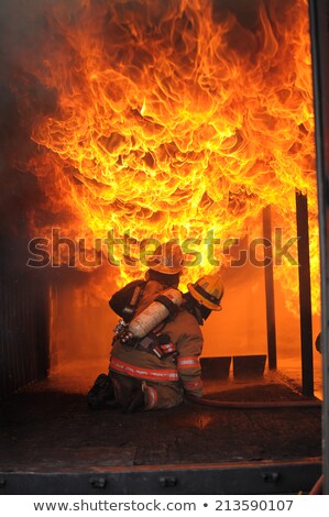 Stock photo: Firefighter Fighting For A Fire Attack