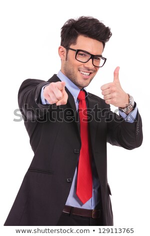 Сток-фото: Young Man With Thumbs Up Pointing Towards Camera