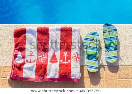 ストックフォト: Bathing Slippers And Bath Towel At Swimming Pool