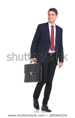 Zdjęcia stock: Side View Of A Walking Young Business Man Looking Away