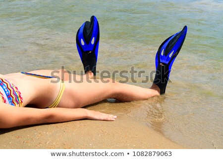 Stock foto: Beautiful Slim Girl At The Sandy Beach With Blue Flippers On Her