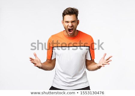 Foto d'archivio: Aggressive Strong And Determined Encouraged Sportsman Yelling And Spread Hands Grimacing Making D