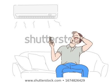 Foto stock: Man Adjusting The Temperature Of Air Conditioner