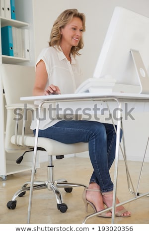 Foto stock: Woman Sitting In A Swivel Chair