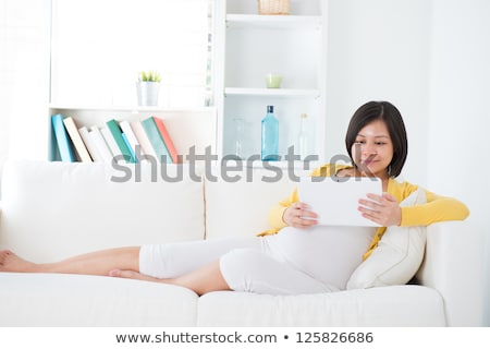 Stockfoto: Young Pregnant Woman Using Touchpad