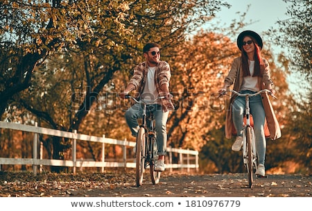 Stock fotó: Young Couple On A Bike Ride Together