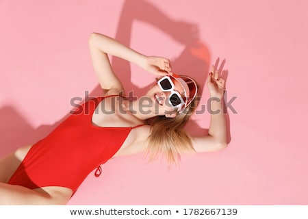 Foto d'archivio: Young Blond Fashionable Woman Posing In A Red Bikini