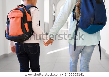 Stock fotó: Two Teenage Girls Studying In Corridor Of School