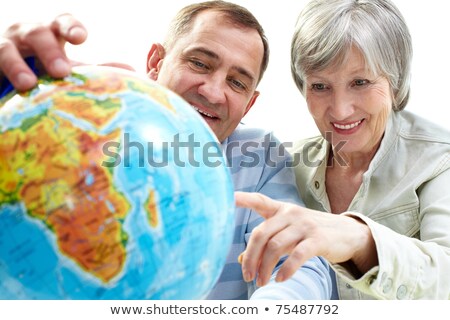 Elderly Man Looking At A Globe Stockfoto © Pressmaster