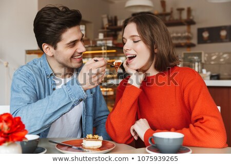 Stock fotó: Portrait Of Happy Couple Dating While Man Feeding Girl With Tas