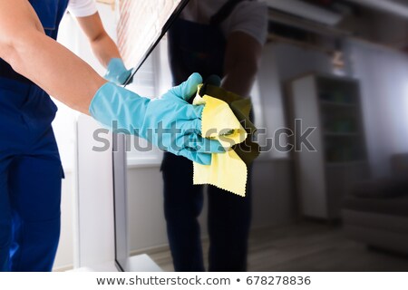 Stockfoto: Male Janitor Cleaning Television