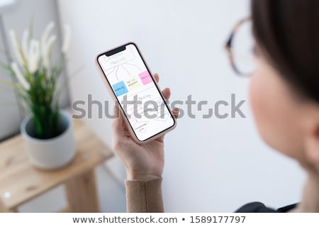 Stockfoto: Hand Of Contemporary Businesswoman Looking Through Decision Making Flow Chart