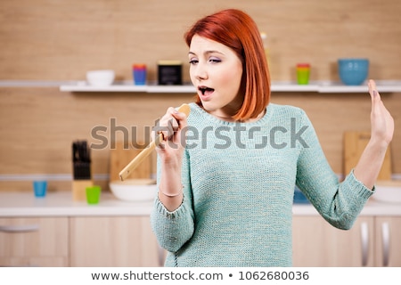 Foto stock: Beautiful Redhead Woman Singing