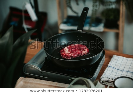 Stok fotoğraf: A Piece Of Delicious Fresh Raw Pork Close Up On A Cast Iron Skillet On The Table Rustic Kitchen