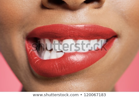 商業照片: Close Up Of Woman With Red Lipstick Biting Lip