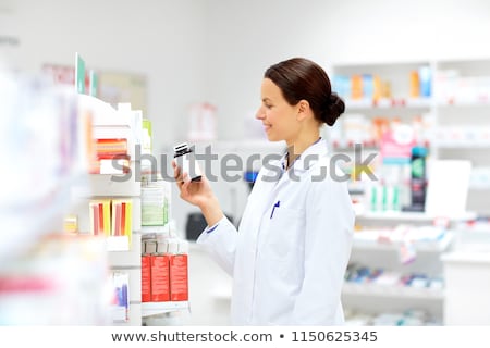 Сток-фото: Happy Female Apothecary With Drug At Pharmacy