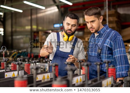 Two Young Men Checking New Industrial Processing Equipment 商業照片 © Pressmaster