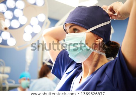 Stock photo: Surgeon Tying Surgical Mask In Operation Room