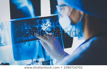 Foto stock: Female Doctor Looking At X Ray