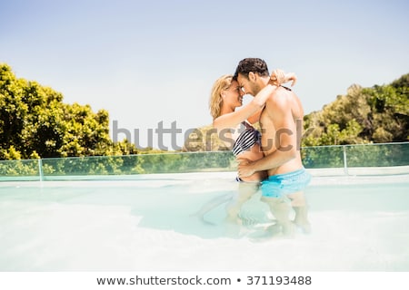 Foto d'archivio: Pretty Young Woman Standing By Swimming Pool