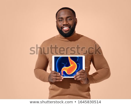 [[stock_photo]]: African Man In Pain Holding His Stomach