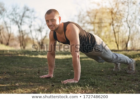 Stock photo: Sporty Man Doing Push Up In An Outdoor Gym