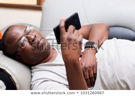 Stock foto: Portrait Of Mature Man Relaxing At Home In Sofa And Cellphone