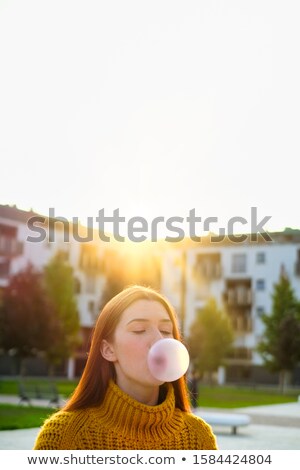 [[stock_photo]]: Young Woman Chewing Gum And Making Big Balloon