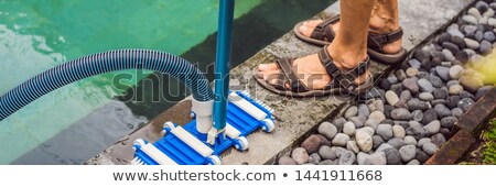 Foto stock: Pool Vacuum Cleaning Flexible Hose On The Pool Banner Long Format