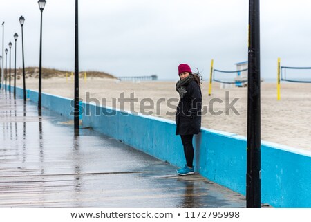 Stock fotó: Woman Standing Behind A Wooden Post