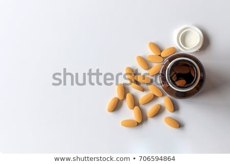 Foto stock: Vitamin C Pills With Medicine Bottle Background