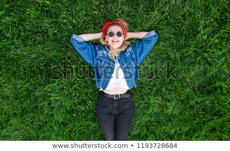 ストックフォト: Young Woman Smiling Laying Down