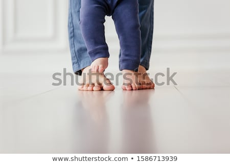 Stock fotó: Bare Feet Of A Young Woman On Blue Bed